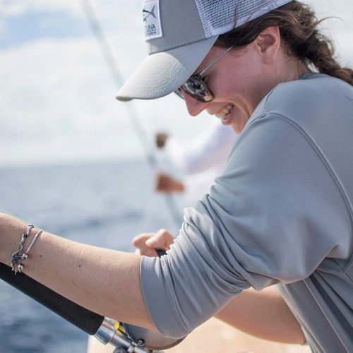 female angler wearing grey with fising pole