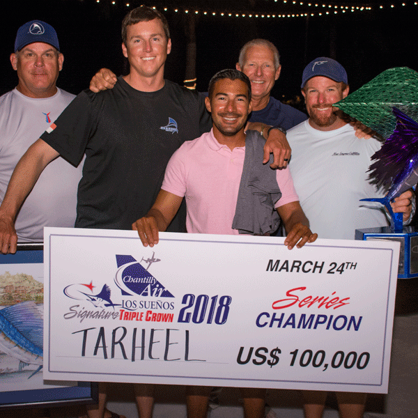 Team Tarheel holding check with tournament prize money